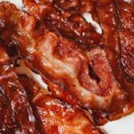Close-up of cooked crispy bacon slices perfect for breakfast or brunch.