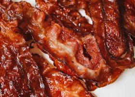 Close-up of cooked crispy bacon slices perfect for breakfast or brunch.