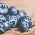 Macro shot of fresh blueberries on wood. Perfect for healthy food concepts.