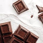 Delicious dark chocolate bars on a marble surface, captured in food photography style.