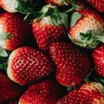 Vibrant close-up image showcasing fresh ripe strawberries, highlighting their rich color and juicy texture.