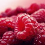 Detailed close-up of fresh, vibrant, and ripe raspberries, showcasing their delicious texture and vivid color.